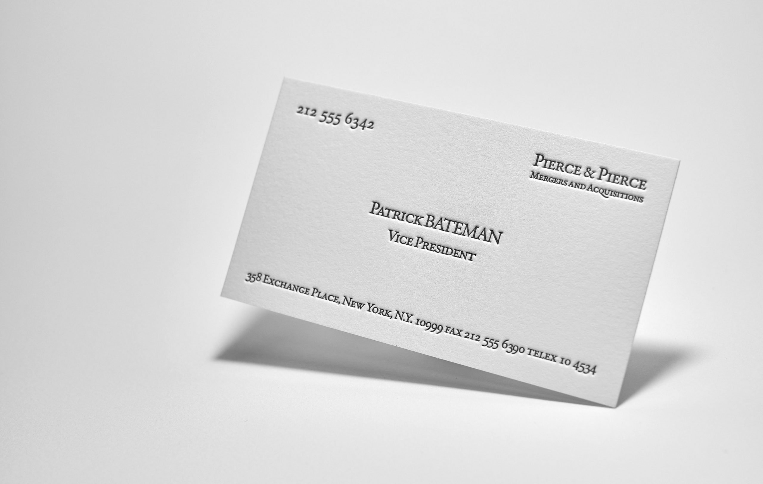 What are the key design elements of Patrick Bateman's business card and